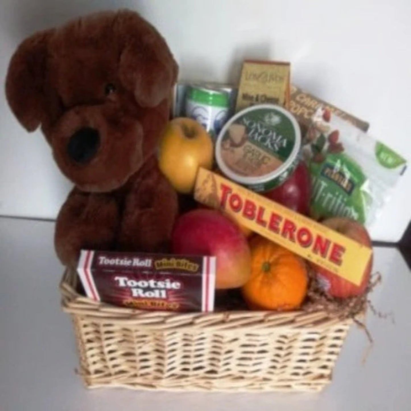 A-get-well-soon-gift-basket, with fresh fruits, A Big Soft Fluffy Teddy Bear, and Chocolates in Boston for delivery