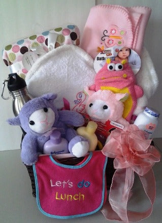 Surprise a new mother and her baby girl in Boston with a basket filled with baby girl personalized blankets, toys, and bath accessories,