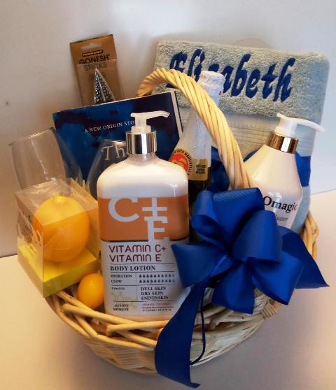 Spa gift basket packed with vitamin E body lotion, personalized towel, and a New York's best-seller book,