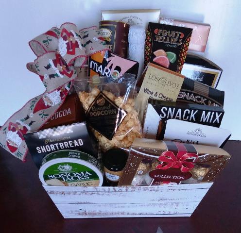 A Christmas Gift Basket packed with fruit jelly candies, gourmet snack mix, hot cocoa mix, nuts, and chocolate. At KJ Paula