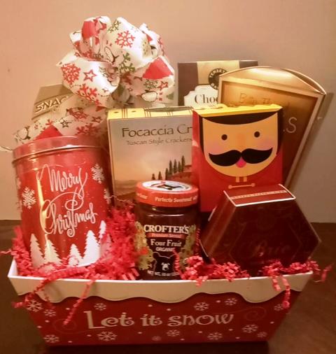 A red and white container filled with holiday cocoa mix, gourmet cookies, and crackers for delivery to Boston zipcode 02199 to Wellesley 02481