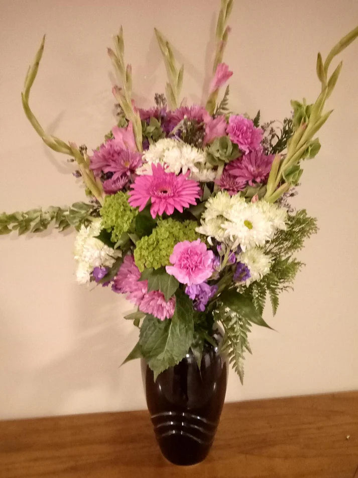 Beautiful flower arrangement in a black flower vase, available at KJ Paula Gift Baskets in Boston
