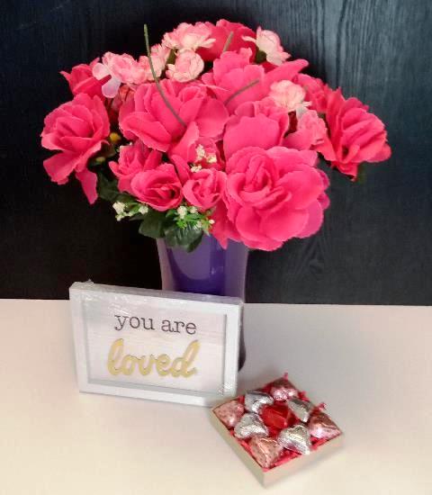 A pink flower arrangement in a purple vase. Available for delivery in Boston, Massachusetts. And downtown Boston waterfront.