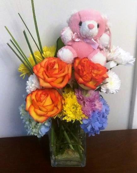 An adorable teddy bear and a stunning arrangement of fresh-cut flowers to congratulate Mom and baby