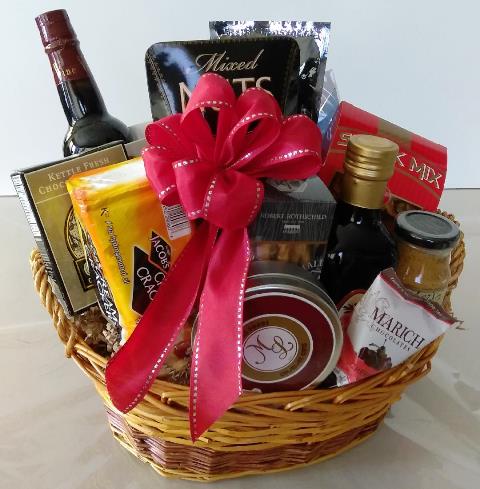A wicker basket packed with olive oil and snacks for any occasion.