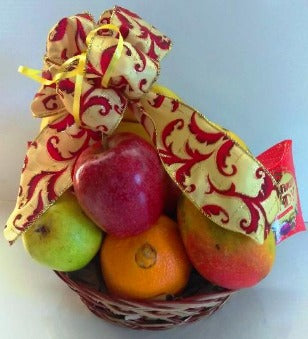 Fruit gift basket packed with Mangos, Oranges, Apples, and hard candies for delivery in Boston, Massachusetts.