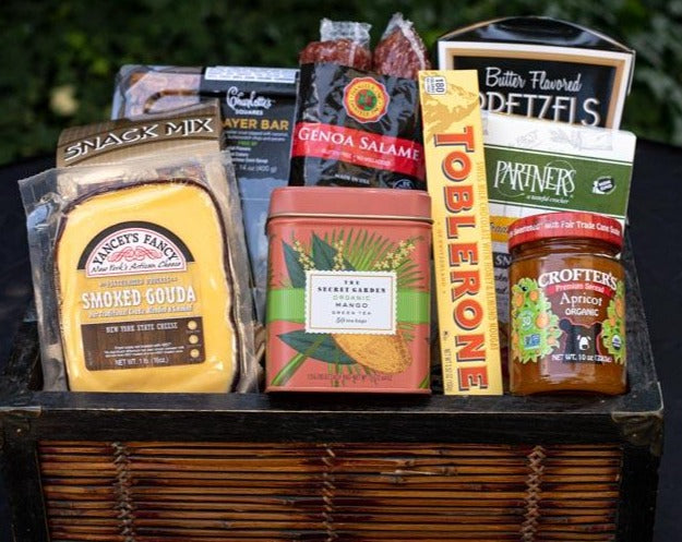 A beautiful wicker gift basket, packed with sweet and savory gourmet snack