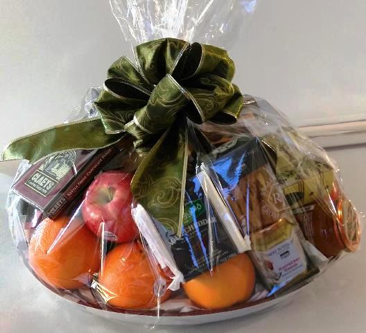 A fruit gift basket with snacks including pretzels, chocolate, cheese, and crackers is available for delivery in Boston.