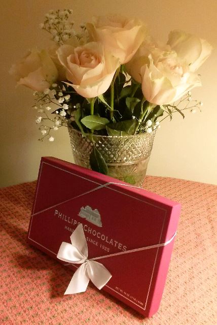 boston-hand-made-chocolates and a beautiful half-white roses in a lovely glass vase. 
