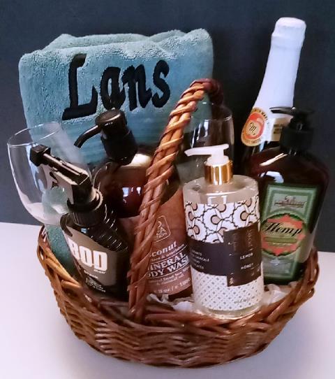 Wicker basket filled with personalized bath towel, lavish bath and body spa items. Available in Boston at KJ Paula Gift. 617-990-7814  