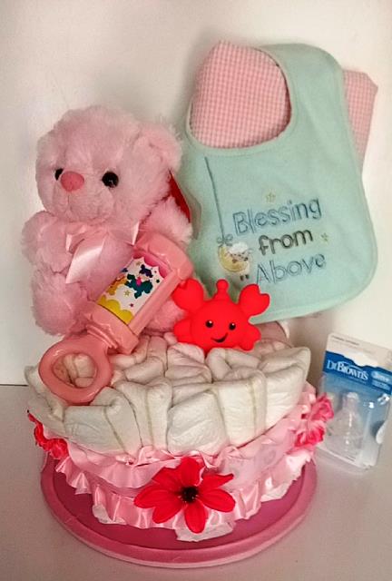 Baby newborn gift basket, diapers, newborn interactive toys, soft plush teddy bear, and baby bib. 