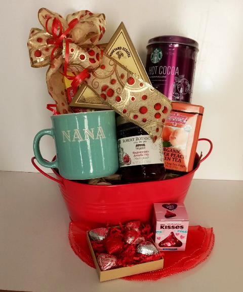 Christmas food snack gift basket for grandma. These Items are display in a red reuse planter container and packed with a variety of gourmet snack and a NANA mug, gourmet cream cheese, hot cocoa mix, gourmet mint tea, chocolates, and a bottle of fruit preserves/