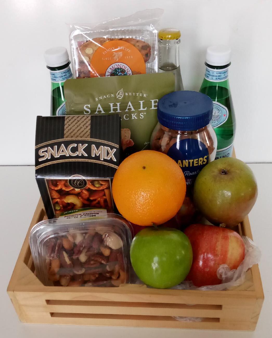 A fruit and snacks gift basket packed with an assortment of fresh fruits, nuts, snack mix, sparkling water and more gourmet snacks.
