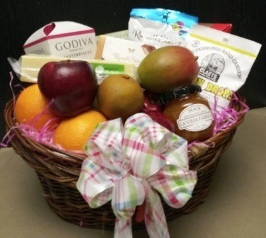 A gift basket with fruits, chocolates, and hard candies at KJ Paula Gift Baskets in downtown Boston for delivery. 617-990-7814