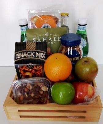 Corporate food and fruit gift basket in Boston. A fruit and snacks gift basket packed with fresh fruits, nuts, snack mix, and sparkling water 