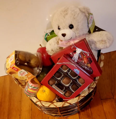 An Easter Gift Basket packed with fruits, chocolates and Teddy Bear for delivery in the Boston area.