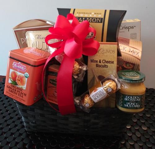 A gourmet-filled food basket with crackers, cheese, dried salmon, and green tea is available at a gift shop in Boston for delivery