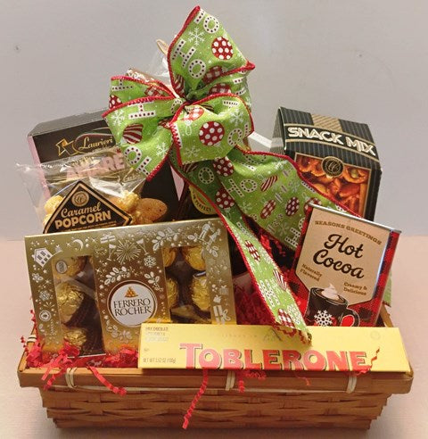 A basket with caramel popcorn, chocolate truffles, creamy hot cocoa mix, gourmet snack mix, and delicious bite-sized chocolate cookies, for Christmas corporate gift in Boston.