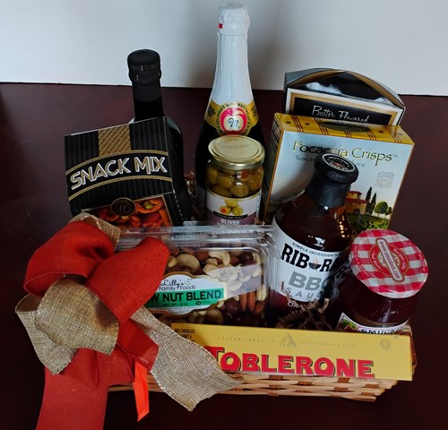 A gift basket filled with BBQ Sauce, nuts, Olive Cooking Oil, crackers, and snacks for delivery in Boston, MA. 