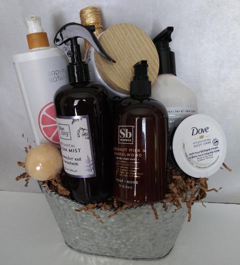 A metal silver gift container filled with bath and body gift items for delivery. This basket is available in Beacon Hill and the Theater District of Boston