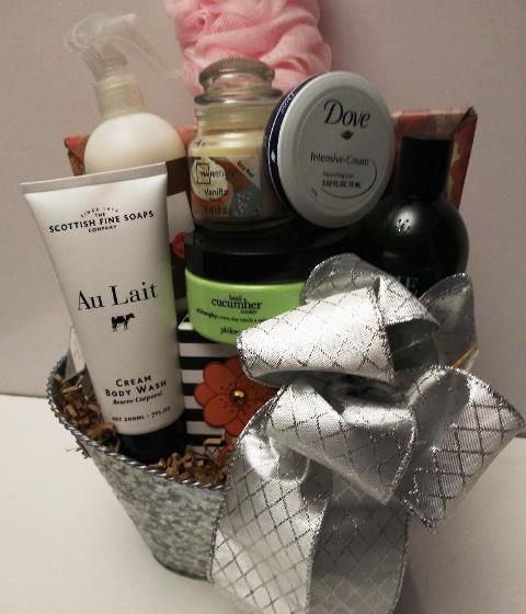 A spa gift basket of bath and body products, and excellent selection for valentine's day gifting. All product are packed into this beautiful reusable metal silver planter are cream body wash, candle, body lotion, beauty bar soap.