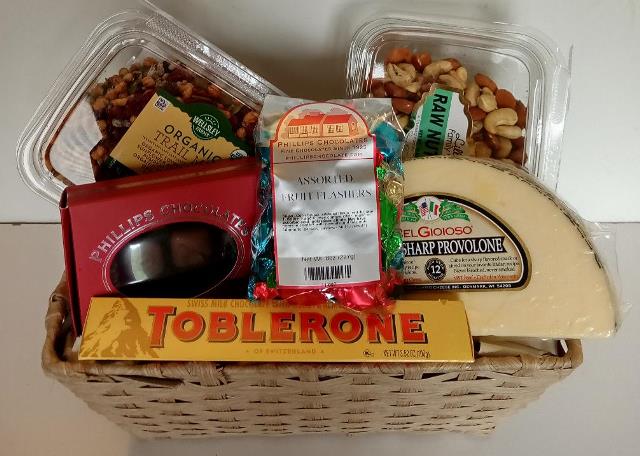 Organic trail nuts, raw mixed nuts, cheese, Boston best chocolates, and candies are packed into this gift basket
