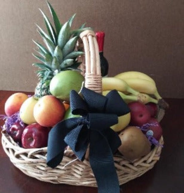 A Fruit gift basket for wishing you sympathy wishes. This wicker gift basket with a handle is packed with mangoes- pineapple, apples, boss pears, red pears, and ripe bananas and tied with a black ribbon for delivery. 
