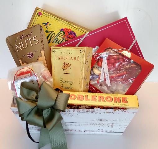 A Christmas gift basket that is packed with a collection of your favorite chocolate, nuts and savory snack.