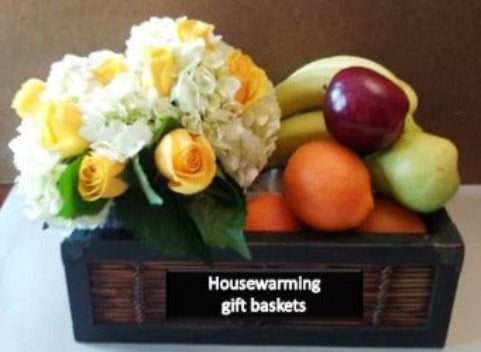 Housewarming gift basket of fruits and floral arrangement. A beautifully crafted gift for any occasion.