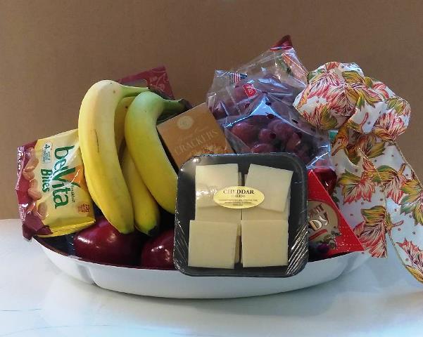 "Indulge in a gift basket loaded with a variety of fresh fruit and berries, combined with a delectable Cheese and Fruit Platter, perfect for any occasion, and available for delivery."