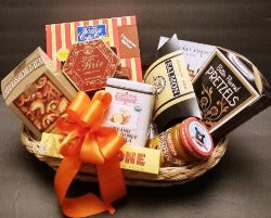 A basket packed with hot cocoa, mixed snacks, and coffee cake is ideal for a thank-you gift basket and KJ Paula will deliver.