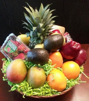 The best fruit basket with pineapple, avocados, sweet juicy mangos, delicious red apples, perfectly riped strawberry, pears, and oranges