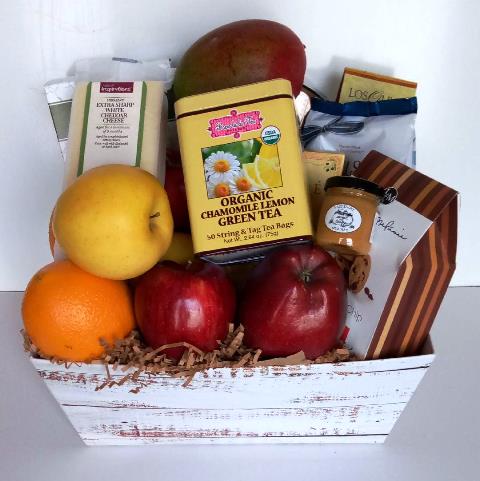 The gourmet snack and fruit gift basket with fresh cheese, organic green tea, pretzels, pretzel dip, chocolate, and crackers.