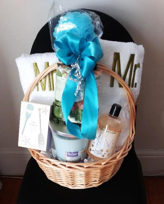 A gift basket filled with Mr. & Mrs. personalized towel sets to celebrate a special occasion. Available at KJ Paula in Boston MA.