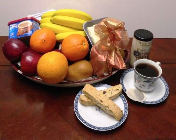 Fruits and Tea Gift Basket packed with ripe banana, oranges, juicy red apples, boss pears, A container of instant coffee, cheese and cookies for delivery within the Boston area